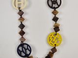 a close up of a necklace with a peace sign on it