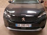 the front end of a black car parked in a garage