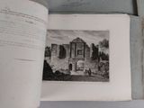 an open book with a picture of a castle on it