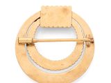 a close up of a brooch with a wooden handle on a white surface