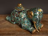 an elephant figurine sitting on a wooden table