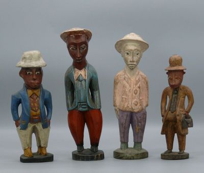 three figurines of men in different colors and hats standing next to each other