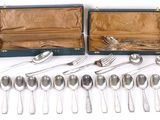 a lot of silver spoons and spoons in a case