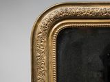 a picture of a man sitting in a chair in front of a mirror