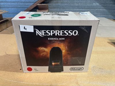 a box of nespresso espresso mini coffee machine on a table