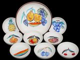 six bowls and a plate with fruit designs on them