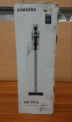 packaging of a samsung jet 70 set in a box on a wooden surface