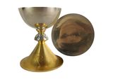 a gold chalicet and a mirror on a white background