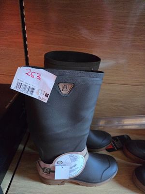 a pair of boots sitting on the floor next to a suitcase