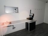 hardwood flooring in a room with a desk and a coffee maker