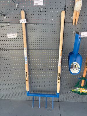 a lot of gardening tools hanging up on the wall