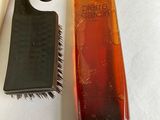 a hair brush and a comb sitting next to each other on a table