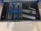 a tool box with tools in it sitting on the floor