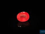 a red apple sitting on top of a black surface