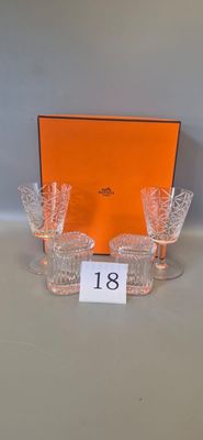 four glasses and an orange box are sitting on a table