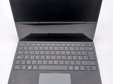 a laptop that is sitting on a white table