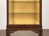 a wooden display case with glass shelves on top of it