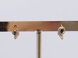 a pair of earrings that are on a stand