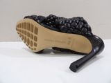 the sole of a pair of black shoes on a white surface