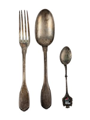 a spoon, fork, and spoon rest next to each other