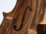 a close up of a violin on a wooden table