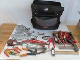 many tools that are sitting on a table next to a bag