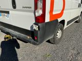 a white van with orange letters parked on the side of the road