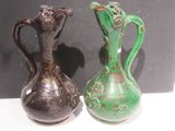 two vases sitting side by side on a table