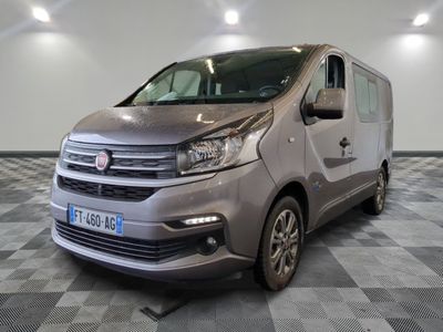 the silver van is parked on a checkered floor in a room