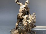 statue of a man on a rock with a bird in his hand