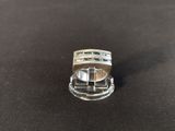 a close up of a silver ring on a black surface
