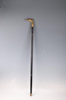 a black and gold cane sitting on top of a white table