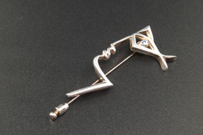 broche en argent ornée d'une pierre bleue et d'un diamant au centre