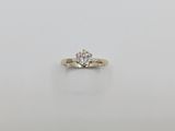 a close up of a diamond ring on a white surface