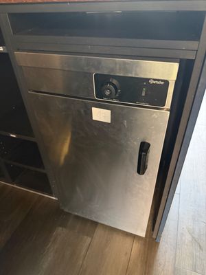 a stainless steel dishwasher in the middle of a kitchen