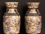 two vases that are sitting on a table