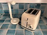 a toaster and a toaster sitting on a tiled floor