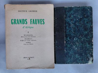 an old book sitting on top of a table next to a blue book