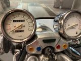 two gauges on the handlebars of a motorcycle