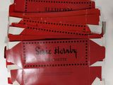 four pieces of red paper with writing on them sitting on a white surface