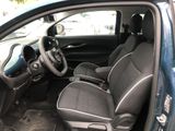the interior of a small car with two seats and a steering wheel