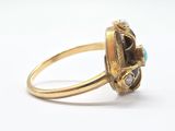 an image of a gold ring with a stone in the center