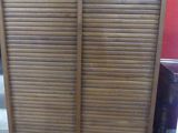 a wooden cabinet that has two doors on it