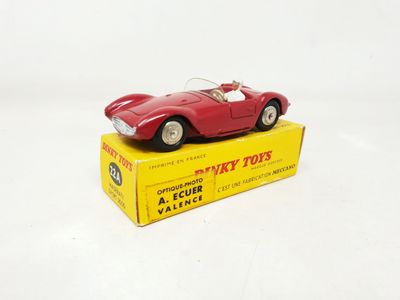 a red toy car sitting on top of a yellow box