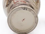a close up of a vase on a white surface