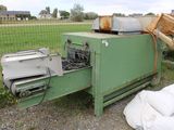a green machine that is sitting in the grass