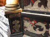 a black and gold chest of drawers sitting on a table
