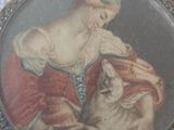 a picture of a woman holding a dog in her lap