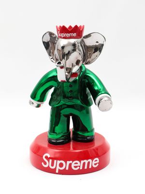 statue of an elephant with a supreme crown on top of it