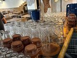 a bar with a lot of glasses and jars on it